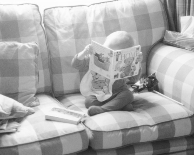An epiphany at about five months; we handed him a book upside down and he turned it around.