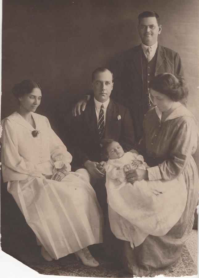 An unknown family.  I found this photo in a junk shop and was so consumed with questions about it; I bought it. Who are these people? Which(if either) of the men is the baby's father? Is the woman holding the baby the mother? A nurse? A godmother? I almost certainly will never know!